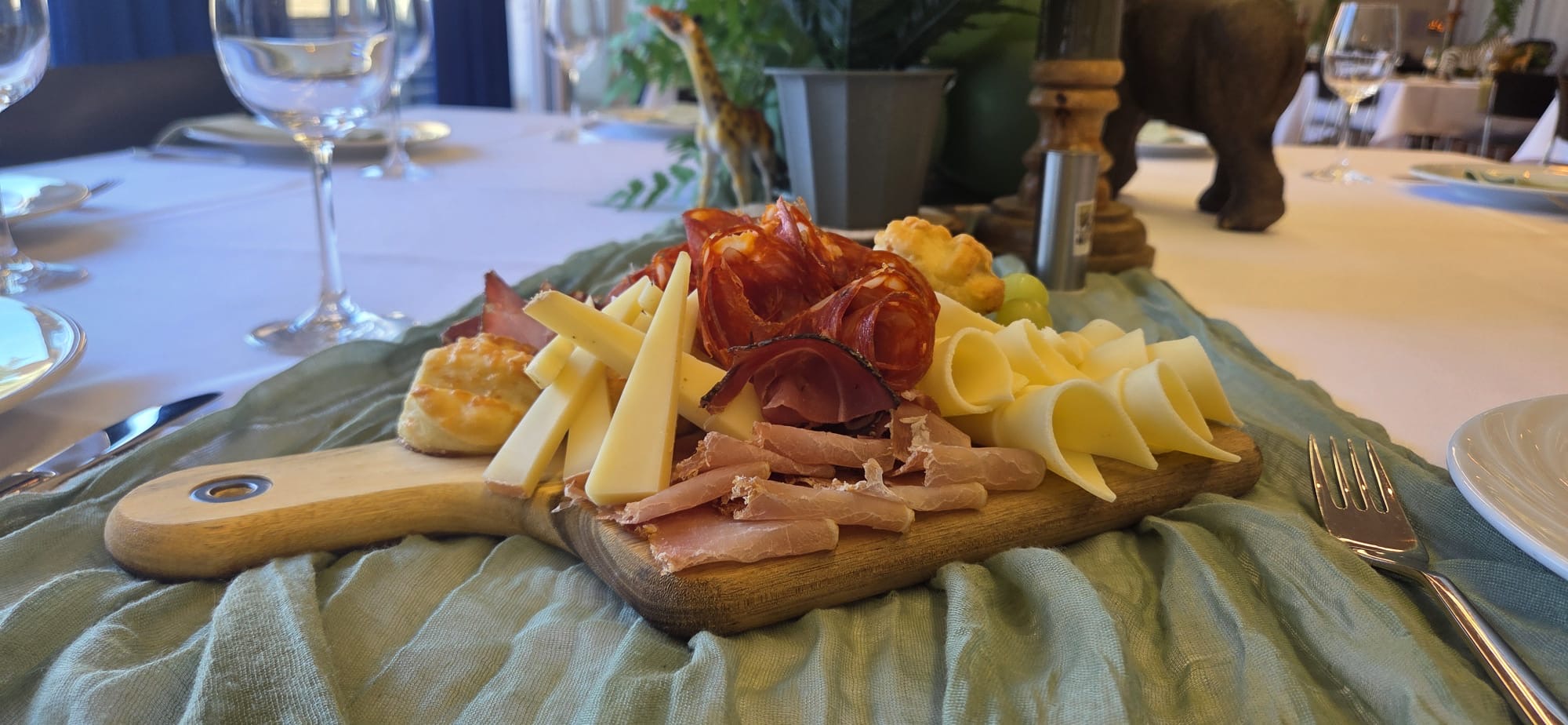 Feine Käse- und Fleischplatte am gedeckten Tisch